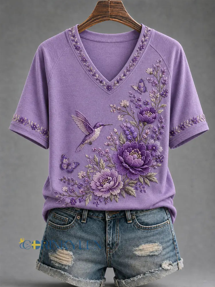 Dammens lila t-shirt med blommor och kolibri påtryck för medvetenhet om Alzheimers med V-ringning - mörkt / S