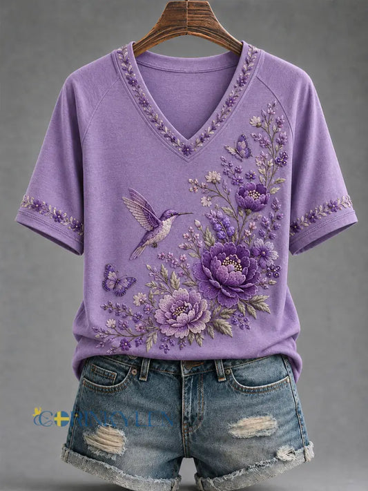 Dammens lila t-shirt med blommor och kolibri påtryck för medvetenhet om Alzheimers med V-ringning - mörkt / S