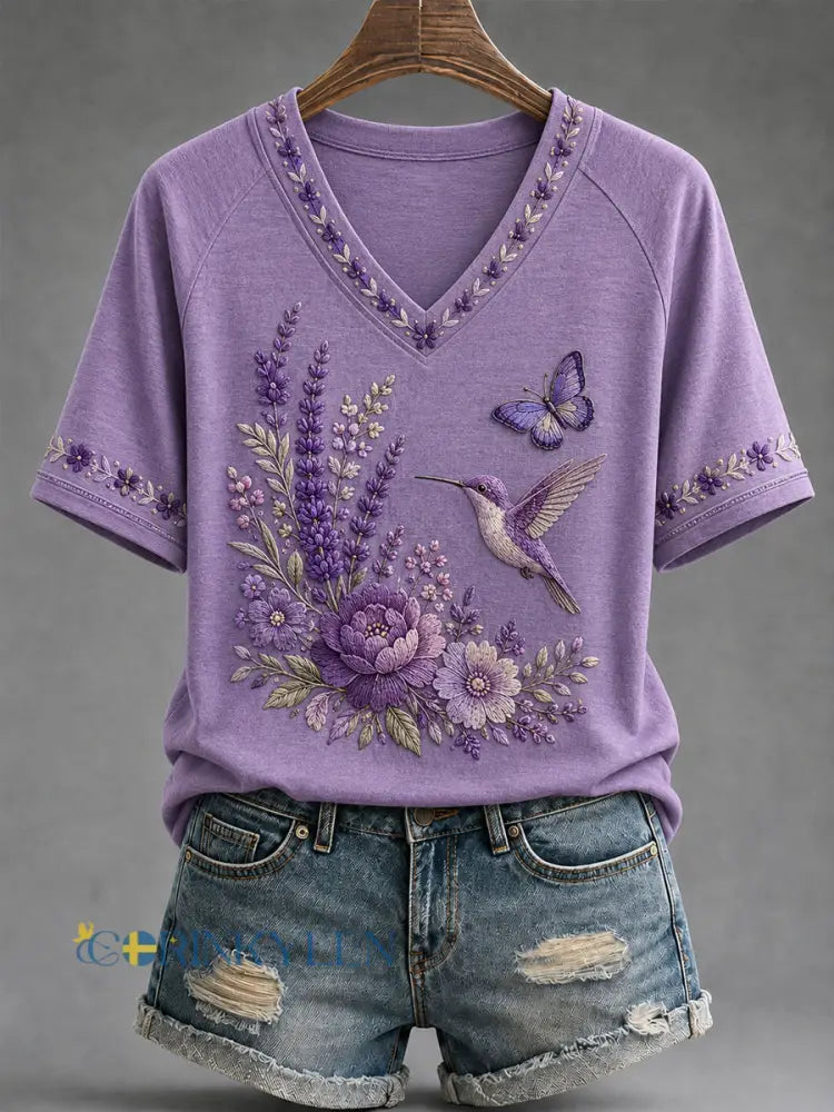 Dammens lila t-shirt med blommor och kolibri påtryck för medvetenhet om Alzheimers med V-ringning - mörkt / S