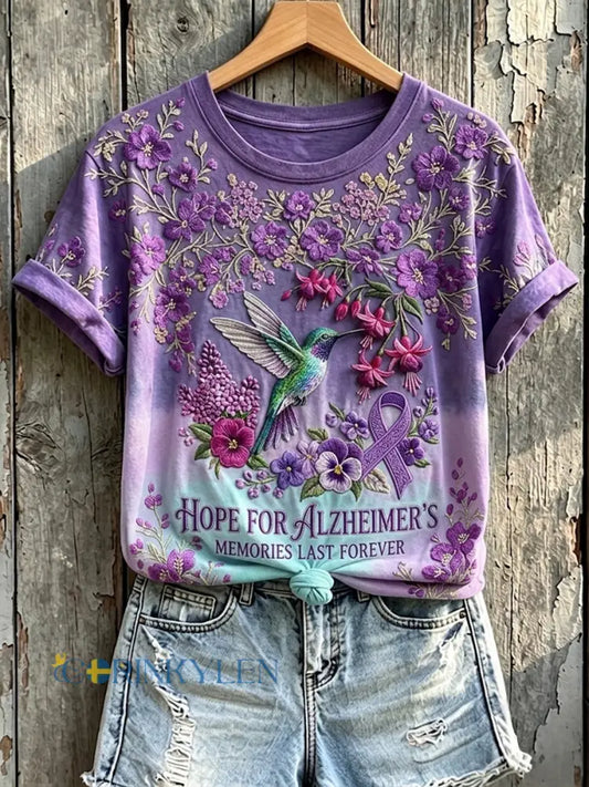 Kvinnors minnen Last Forever Lilla Ribbon Kolibri Skriv ut kortärmad T-shirt - mörkt / S